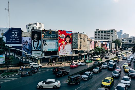 Dynamic cityscape of Bangkok showcasing heavy traffic and colorful billboards in the metropolis.
