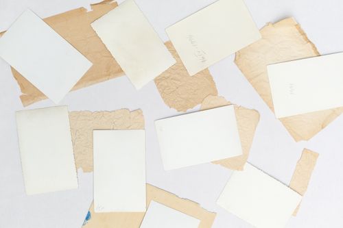 Free A flat lay of vintage papers and blank photo cards on a white surface. Stock Photo