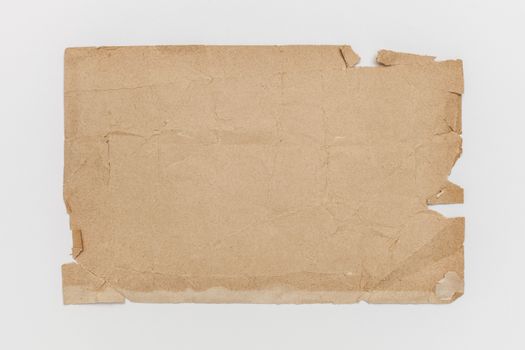 A textured old brown paper with worn edges, perfect for background use.