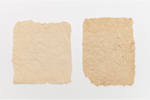 Brown Crumpled Papers On White Surface