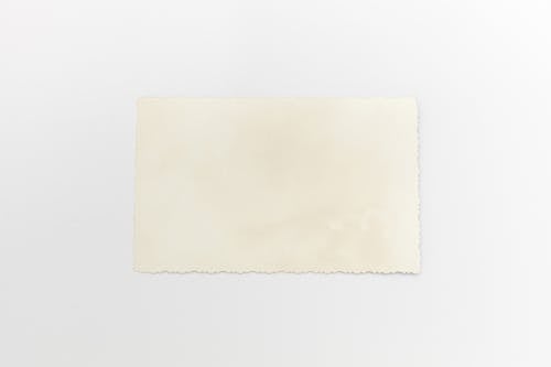 Free Close-Up Shot of a Vintage Paper on a White Surface Stock Photo