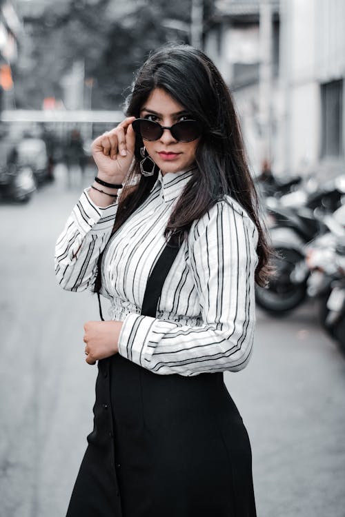 A Woman Wearing Stripe Shirt and Sunglasses
