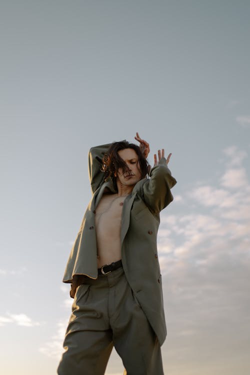 Free Woman in Beige Coat Standing Under White Sky Stock Photo