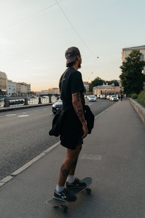 Woman in Black Crew Neck Shirt Skateboarding