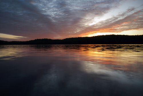 Free Peaceful sunset over Lanark Lake with dramatic clouds reflecting in the water. Stock Photo