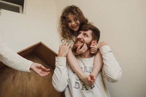 Bearded Man Carrying a Little Girl on His Shoulder