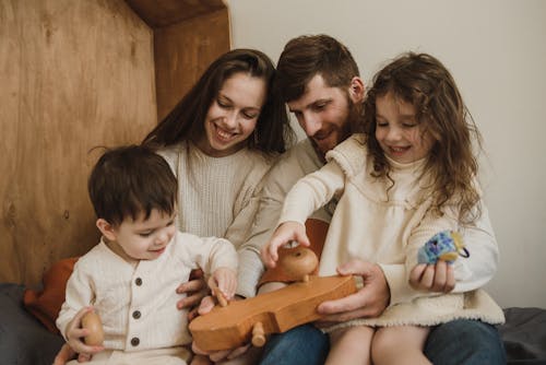 Happy Family Playing with Wooden Toy