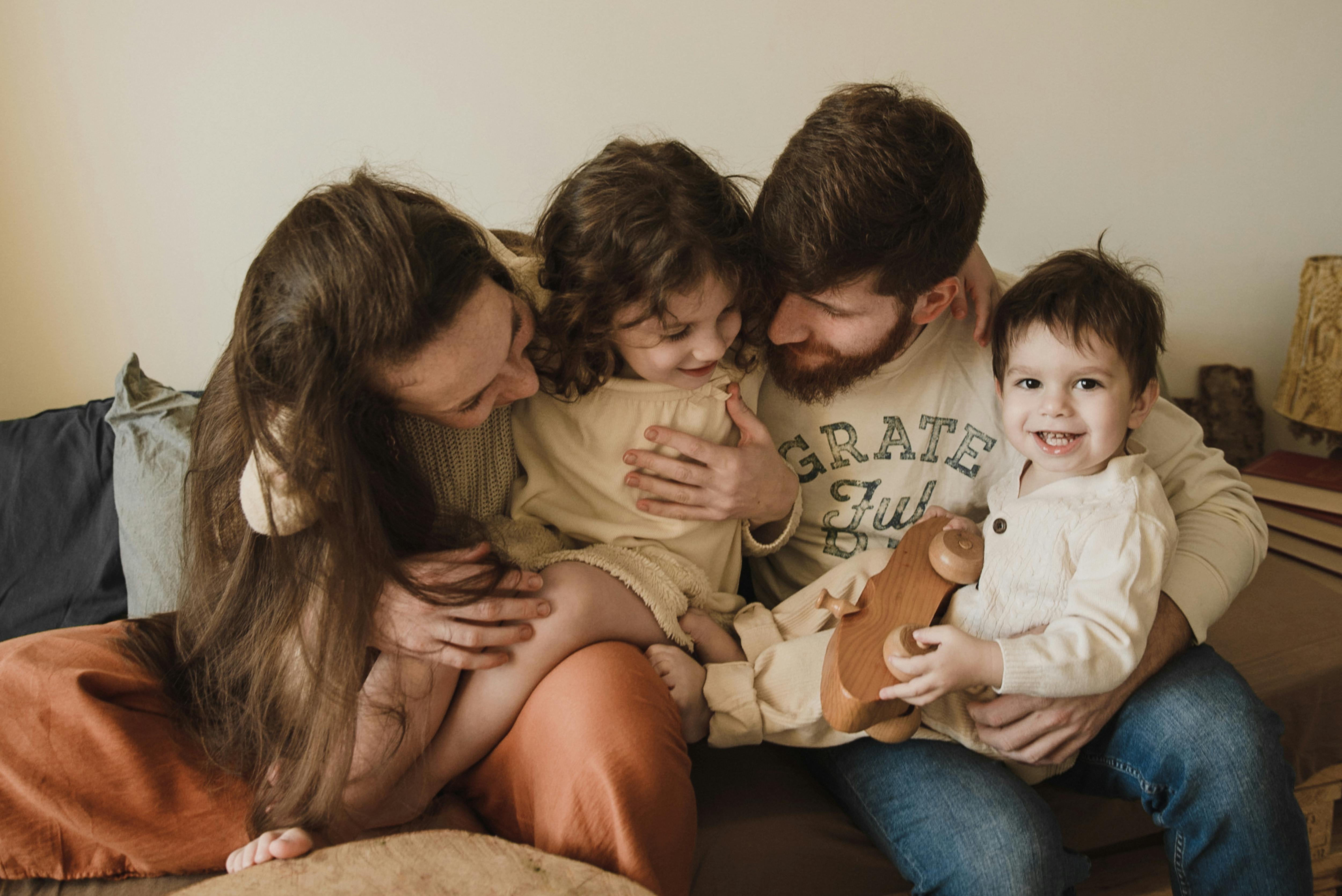 a happy couple with young children