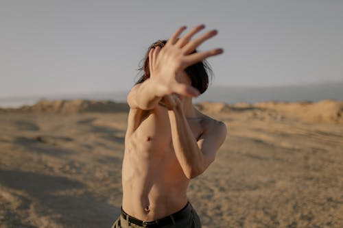 Free Woman in Black Shorts Covering Her Face With Her Hands Stock Photo