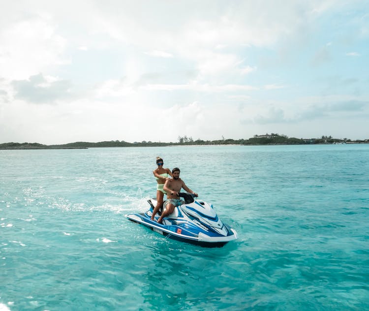 Couple Riding A Jetski 