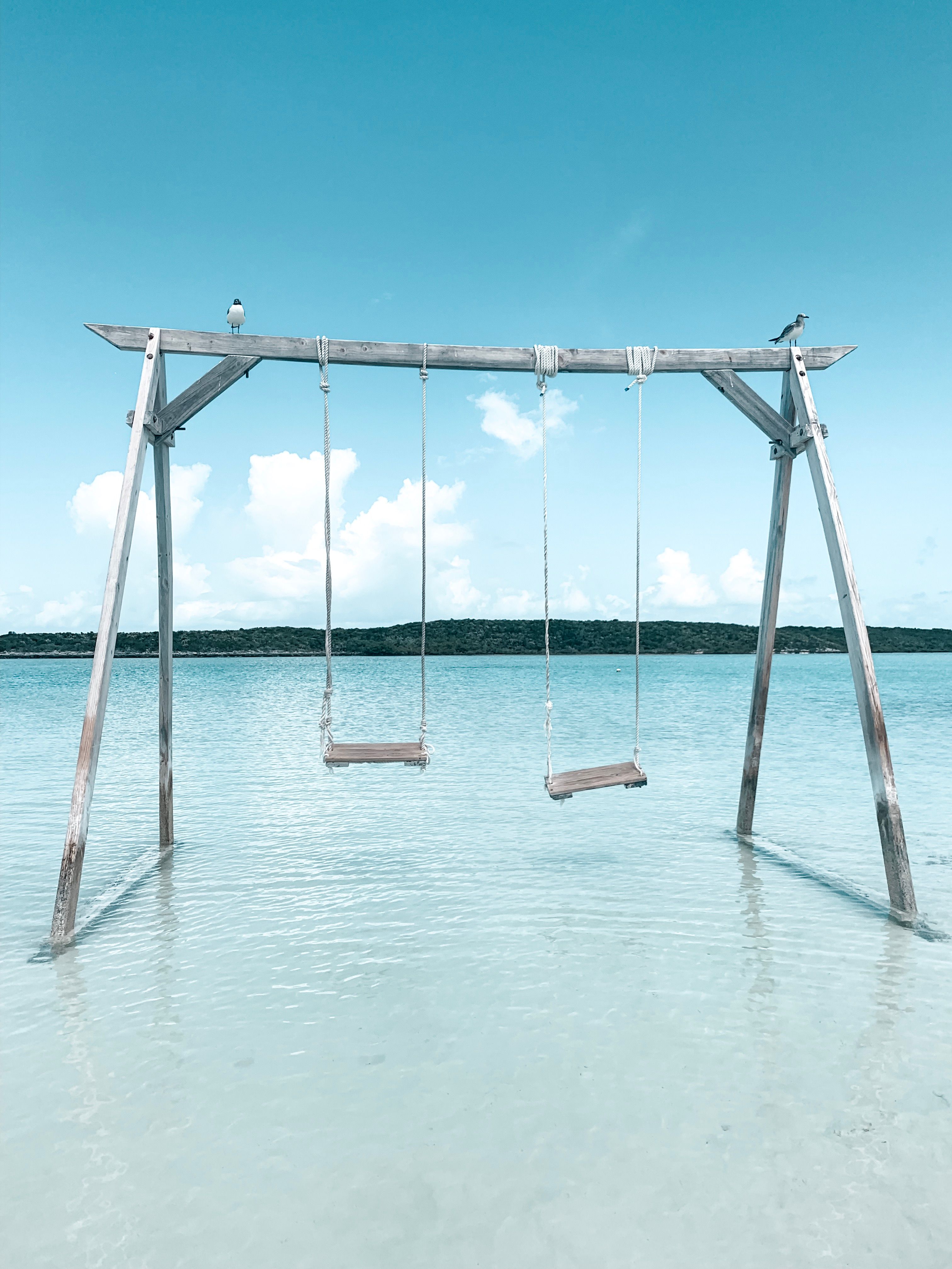 Swing set in shallow, tranquil waters on a sunny day in Exuma, Bahamas.