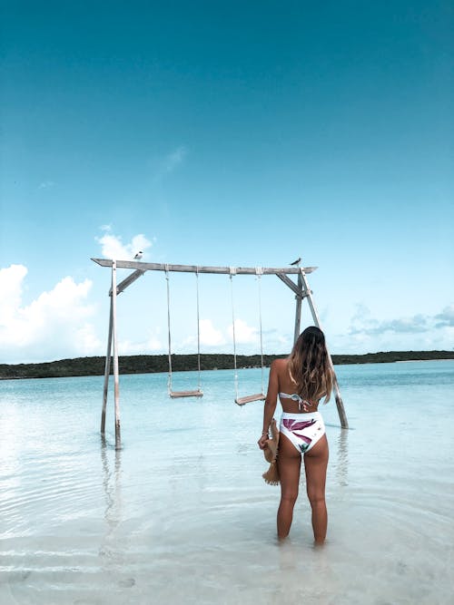 Woman in Bikini Standing on Beach