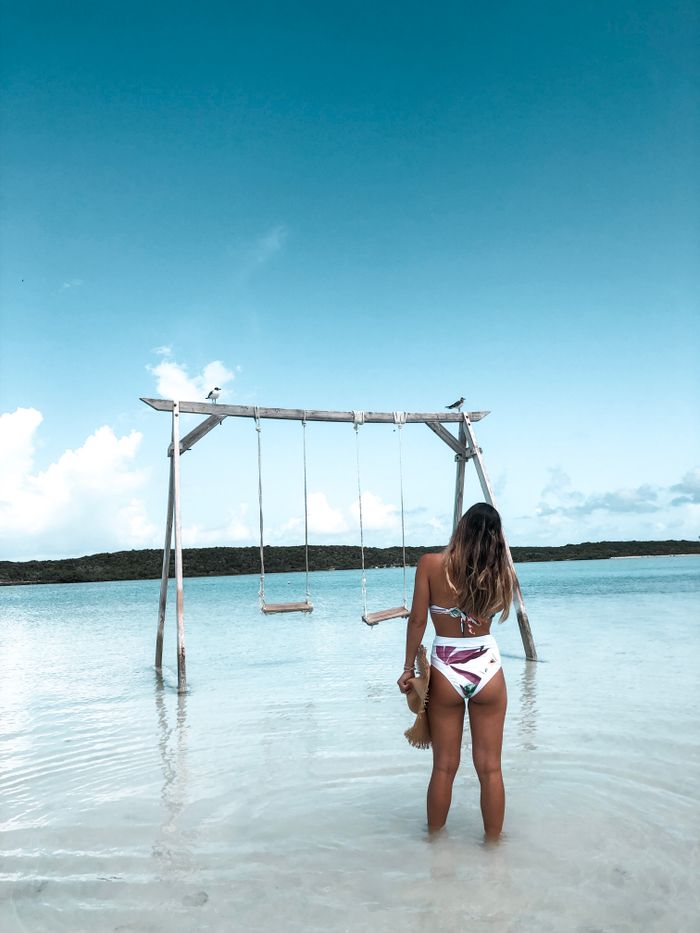 Swings standing in the shallow water of a beach in Exuma