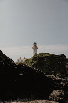 Scenic view of the historic Turnberry Lighthouse against a clear sky, Scotland.