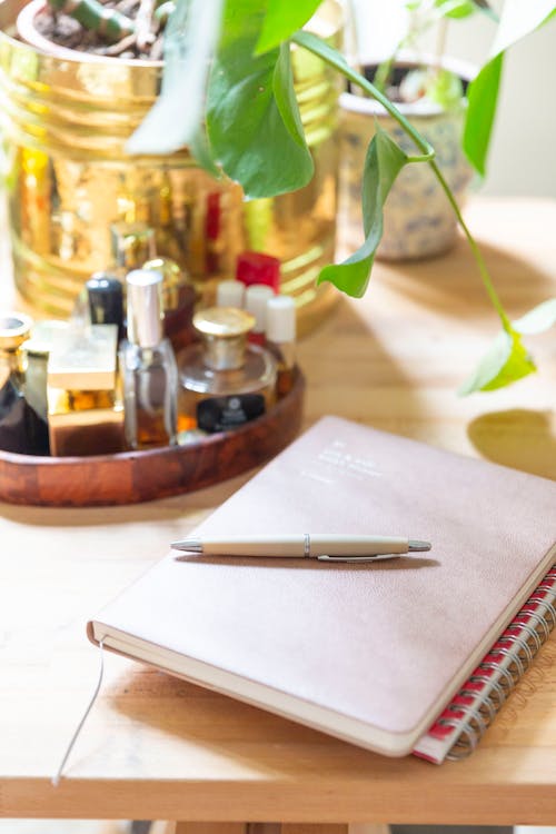 A Pen and a Notebook on a Table