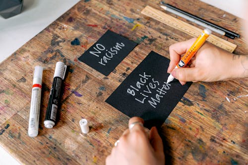 Free A Person Writing Black Lives Matter on a Card Stock Photo