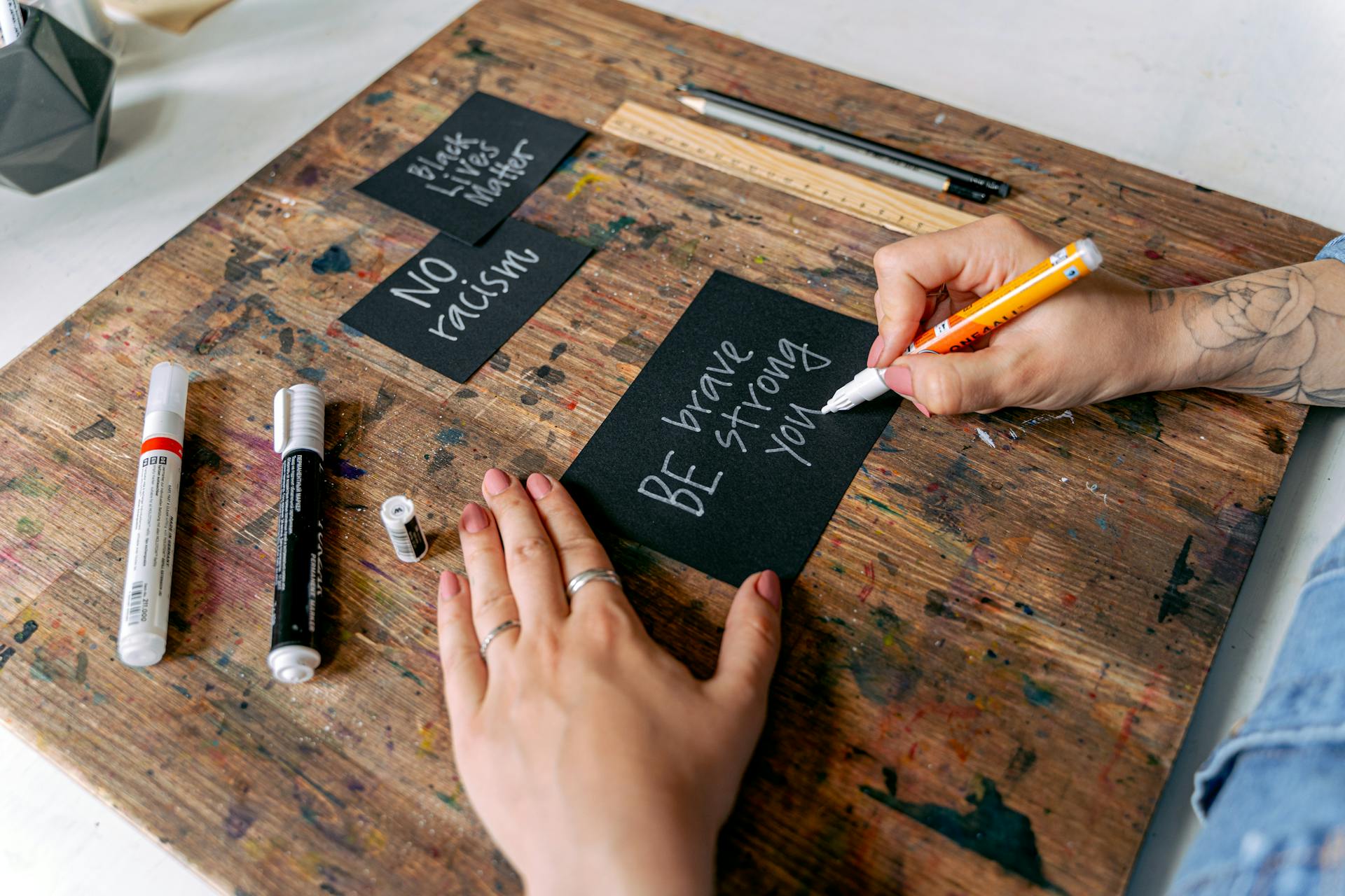 A Person Writing on a Black Card