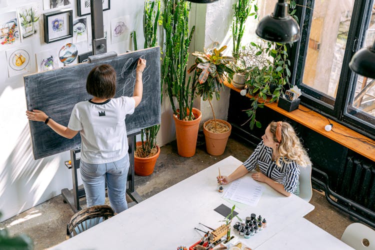 A Teacher And A Student At An Art School