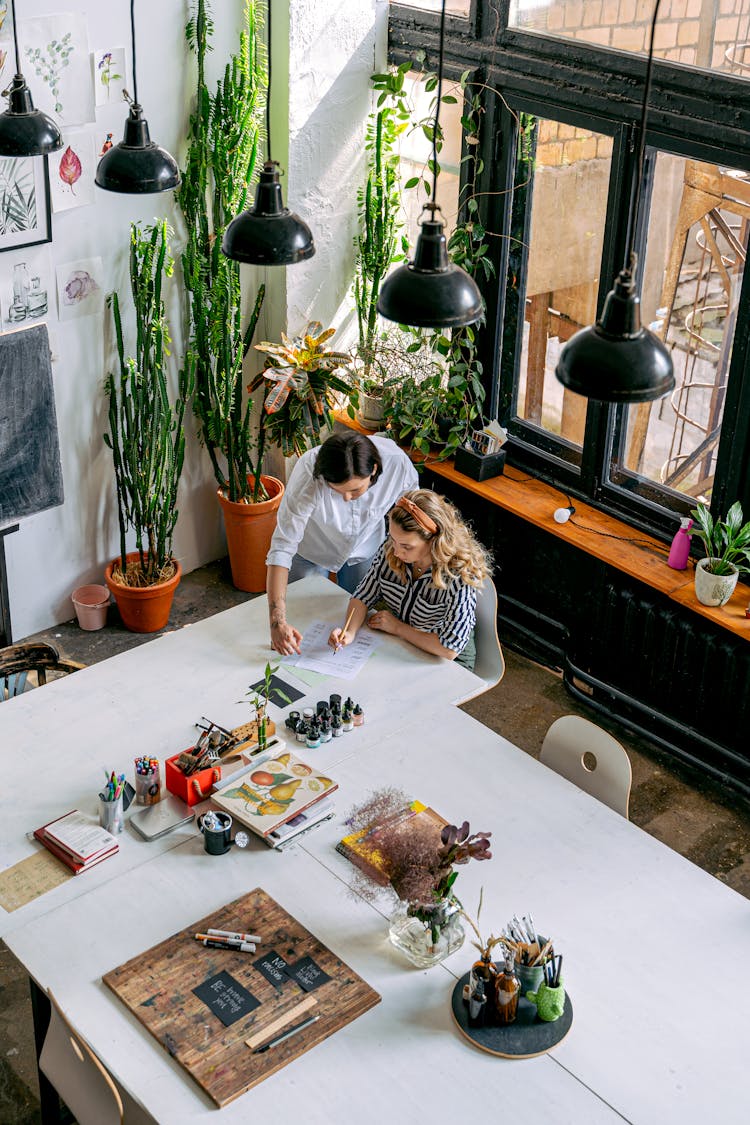 A Woman Teaching A Student At An Art School