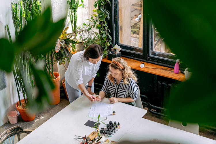 A Woman Teaching A Student At An Art School