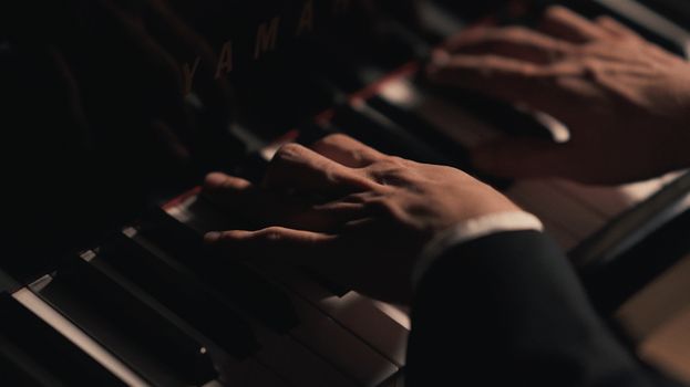 Artistic shot of a musician playing a piano, capturing the elegance and passion of music.