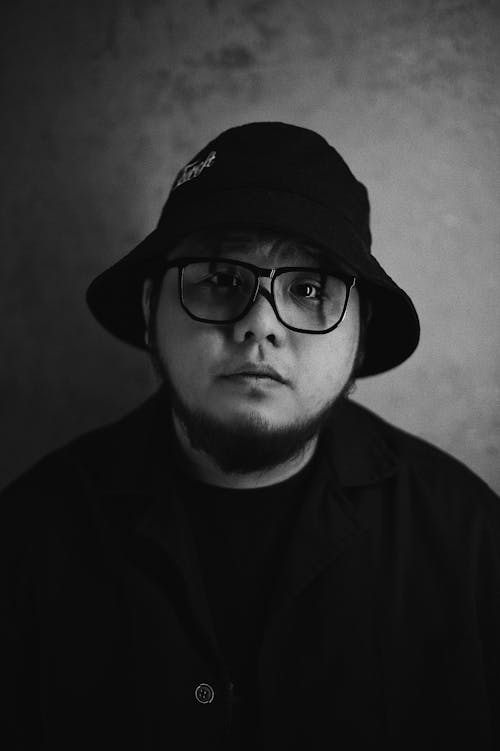 Grayscale Photo of a Young Man in a Bucket Hat