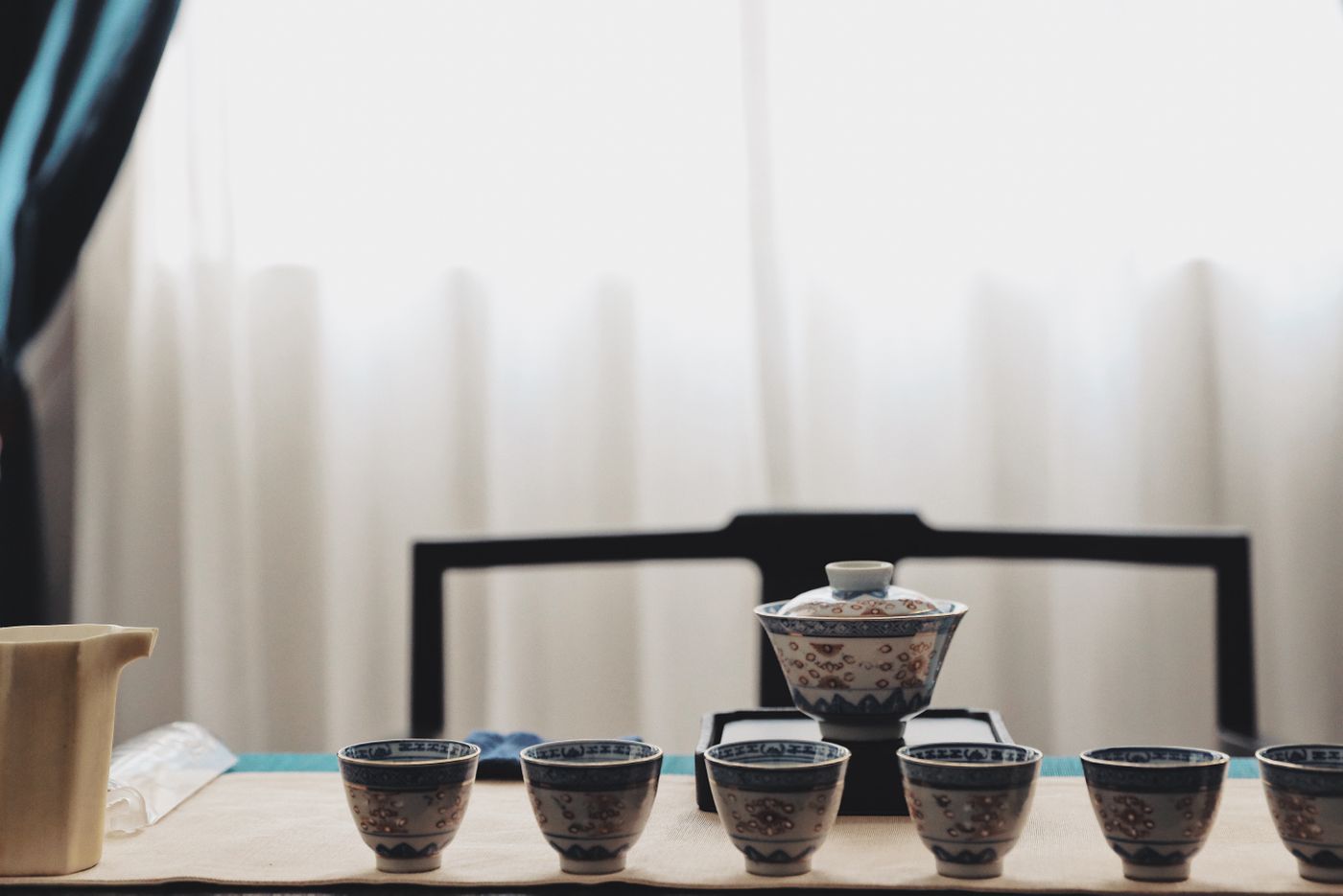 A Chinese tea set arranged on a wooden table in soft natural light