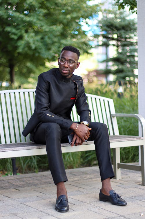 Stylish Man sitting on a Bench 