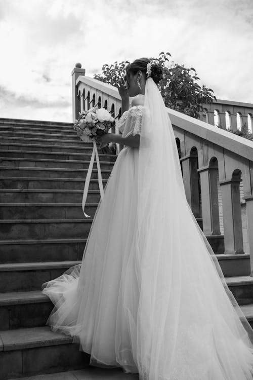 Backview of Bride standing on Stairs