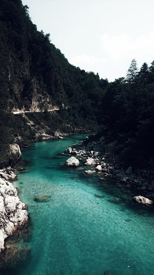 Narrow river flowing through mountainous terrain