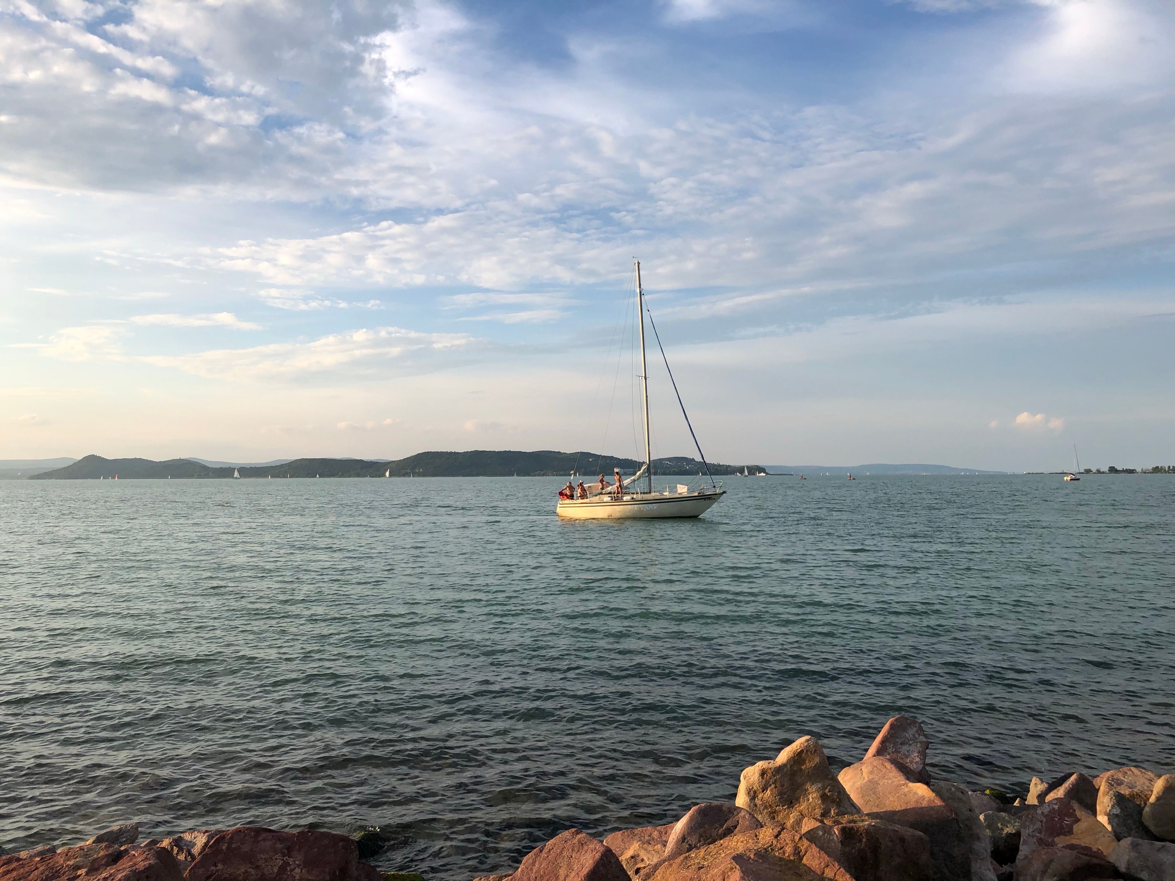 White Boat Sailing on the Sea Under Cloudy Sky · Free Stock Photo