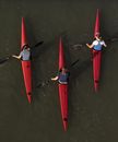 Man in Black Shirt and Blue Denim Jeans Riding Red Kayak