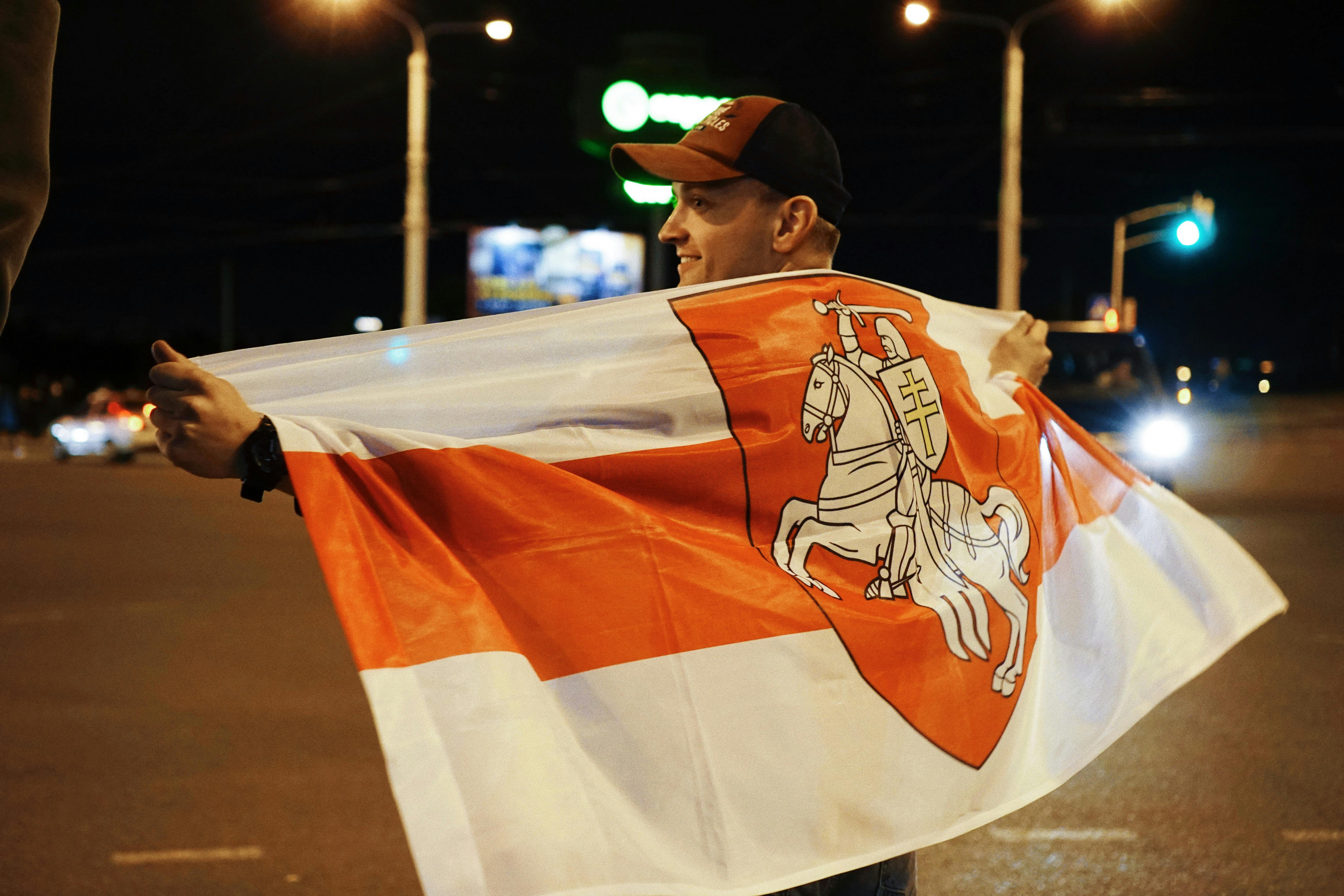 protester holding belarusian flag