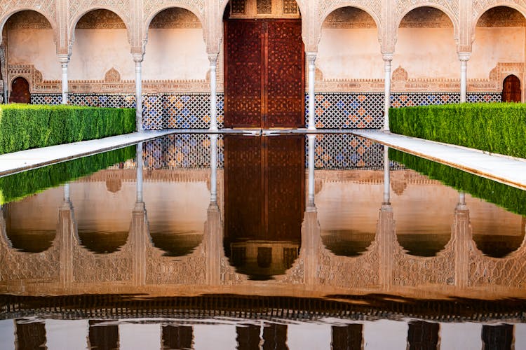 Reflection Of Alhambra Palace On The Swimming Pool