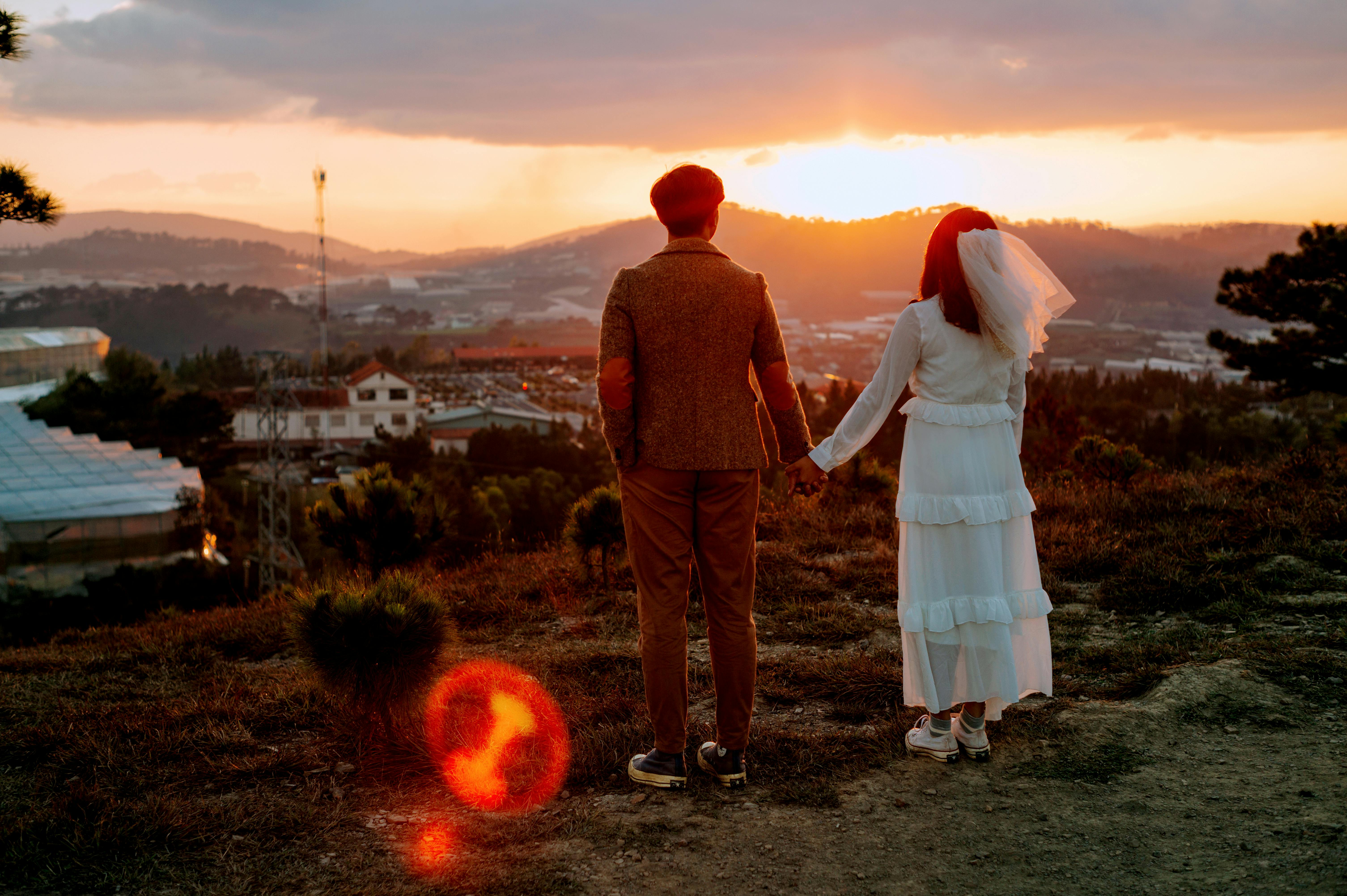 young newlyweds on hill above city