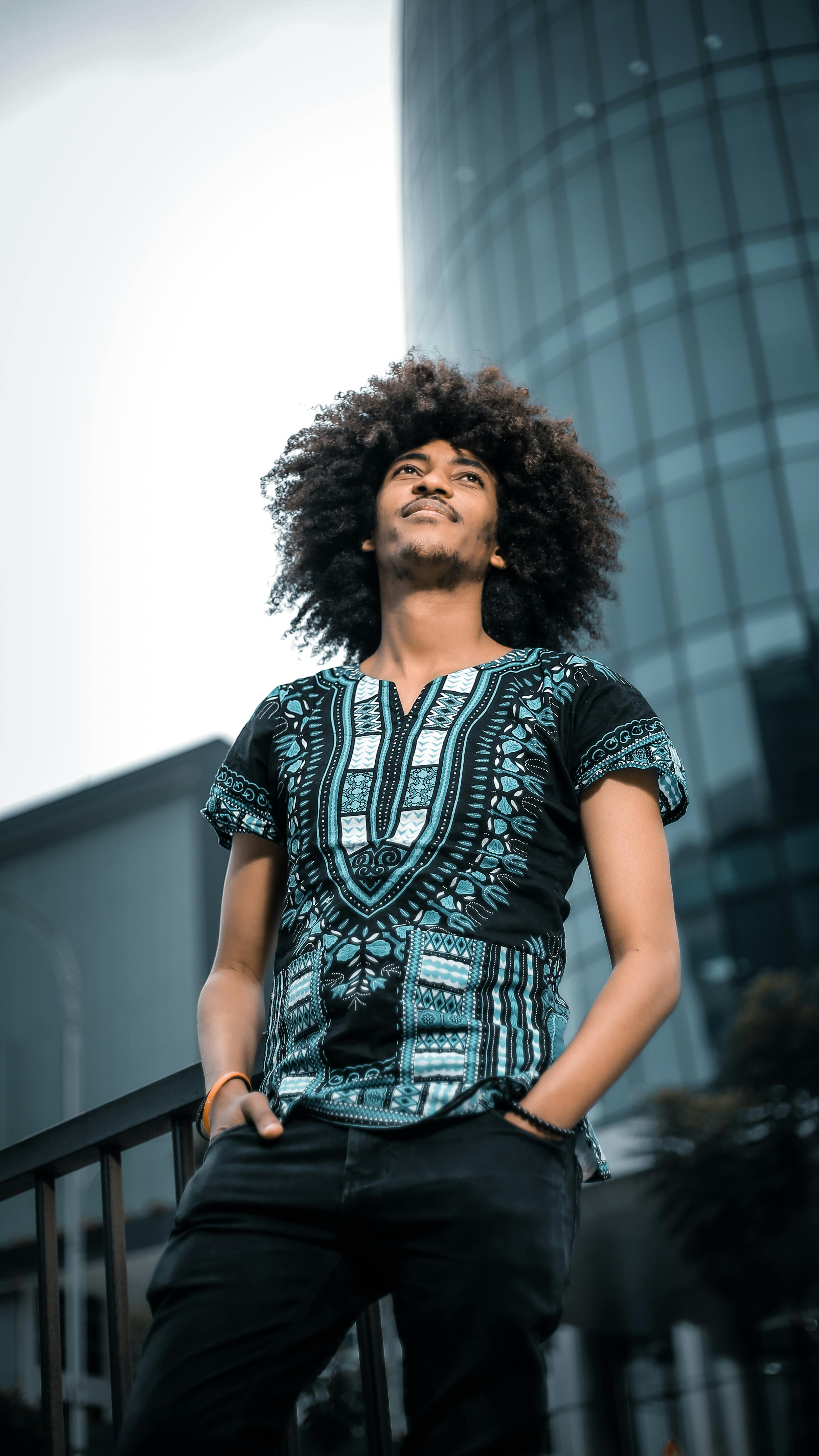 Low-Angle Shot of an Afro-Haired Man Standing · Free Stock Photo