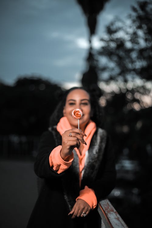 A Woman Holding a Lollipop