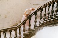 Woman in White Dress on Staircase