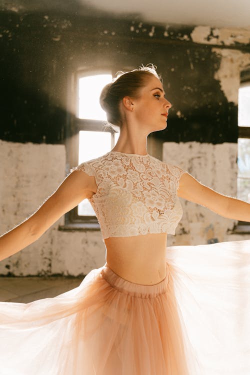 Woman in White Lace Crop Top and Tutu Skirt