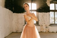 Woman in White Sleeveless Dress Standing on Gray Concrete Floor
