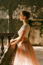 Girl in White and Pink Dress Standing on Gray Concrete Floor