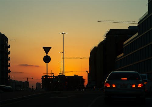 Foto d'estoc gratuïta de ciutat, cotxes, posta de sol daurada