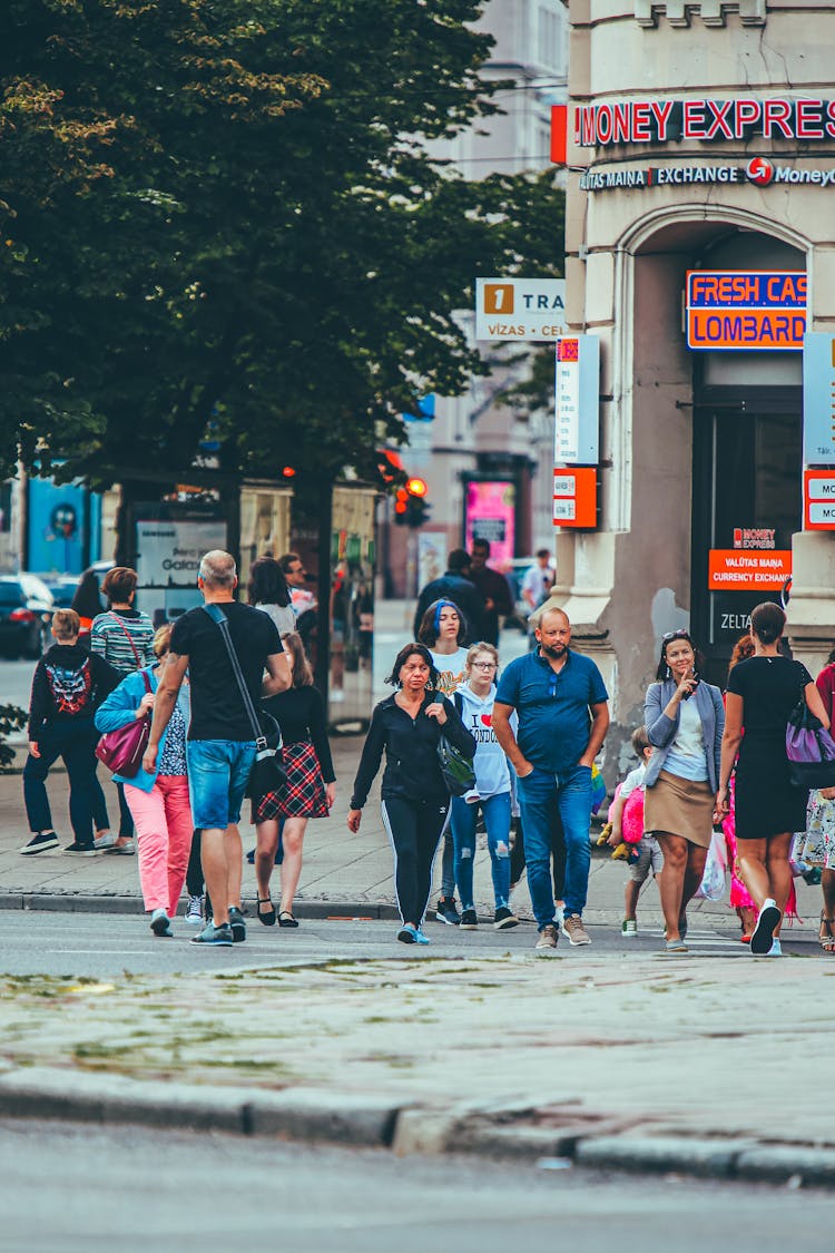 Crowd Of People Crossing Street In Busy Town