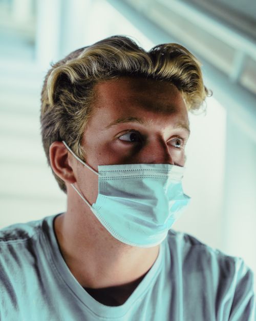 Free Portrait of a young man wearing a face mask, highlighting new normal themes. Stock Photo