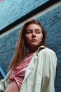 Girl in White Button Up Shirt Standing Beside Blue Metal Railings