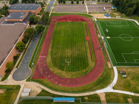 Aerial view of track and soccer field in Menomonie, WI, showcasing sports facilities from above.