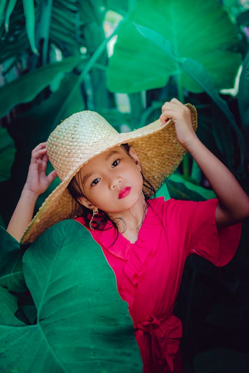 Free A Girl In Pink Dress and Wearing a Straw Hat Stock Photo