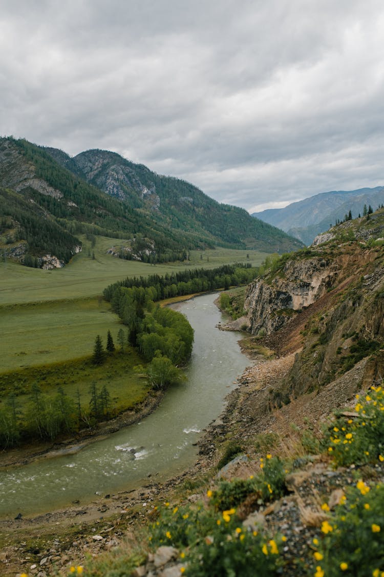 Narrow River Flowing Through Mountainous Valley