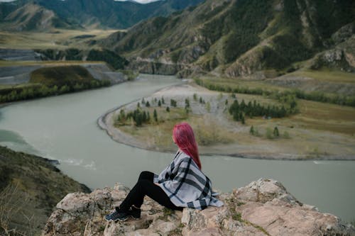 Woman enjoying view of river in mountains