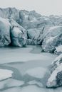 Grayscale Photo of River in Between Rocky Mountains